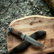 Тактически нож с полуизвито острие и дървена дръжка на бял фон.