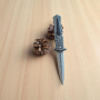 Сгъваем нож Ornamental Dagger върху шишарка и зелени дъски
